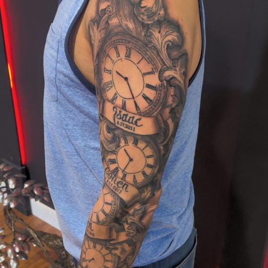 Picture of a mixed style realism and traditional clock sleeve tattoo.