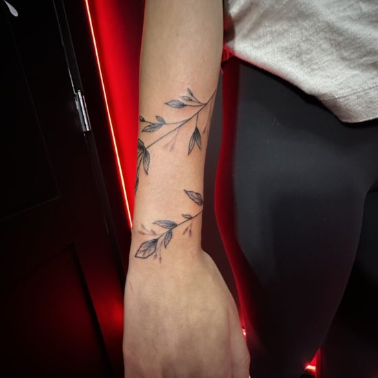 Picture of a wrapping vine tattoo.