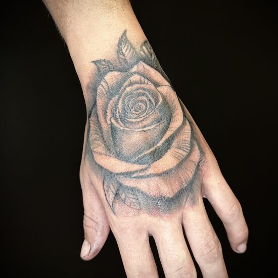 Realism rose hand tattoo